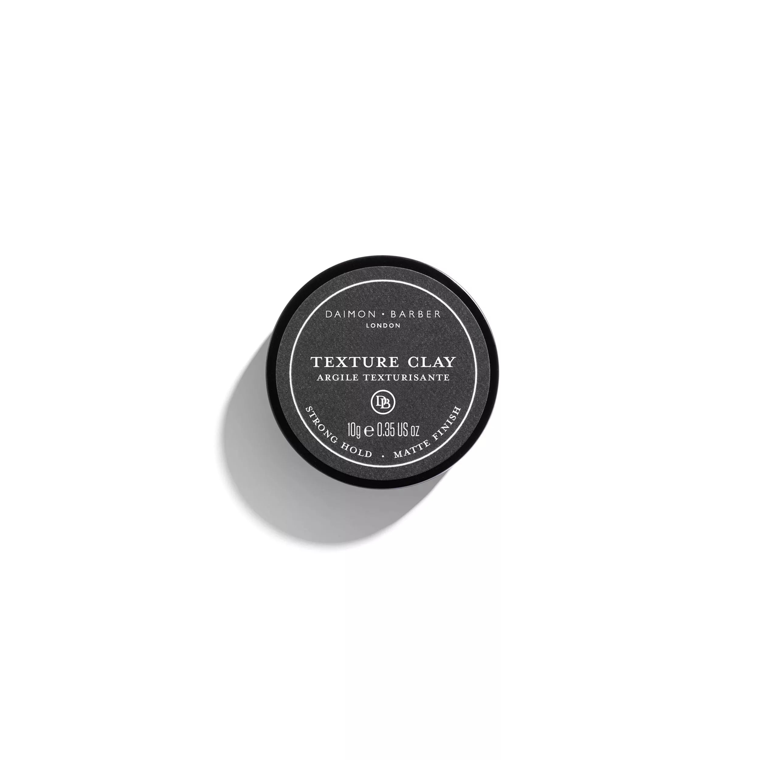 Over the top image of Daimon Barber Texture Clay 10g lid on a white background