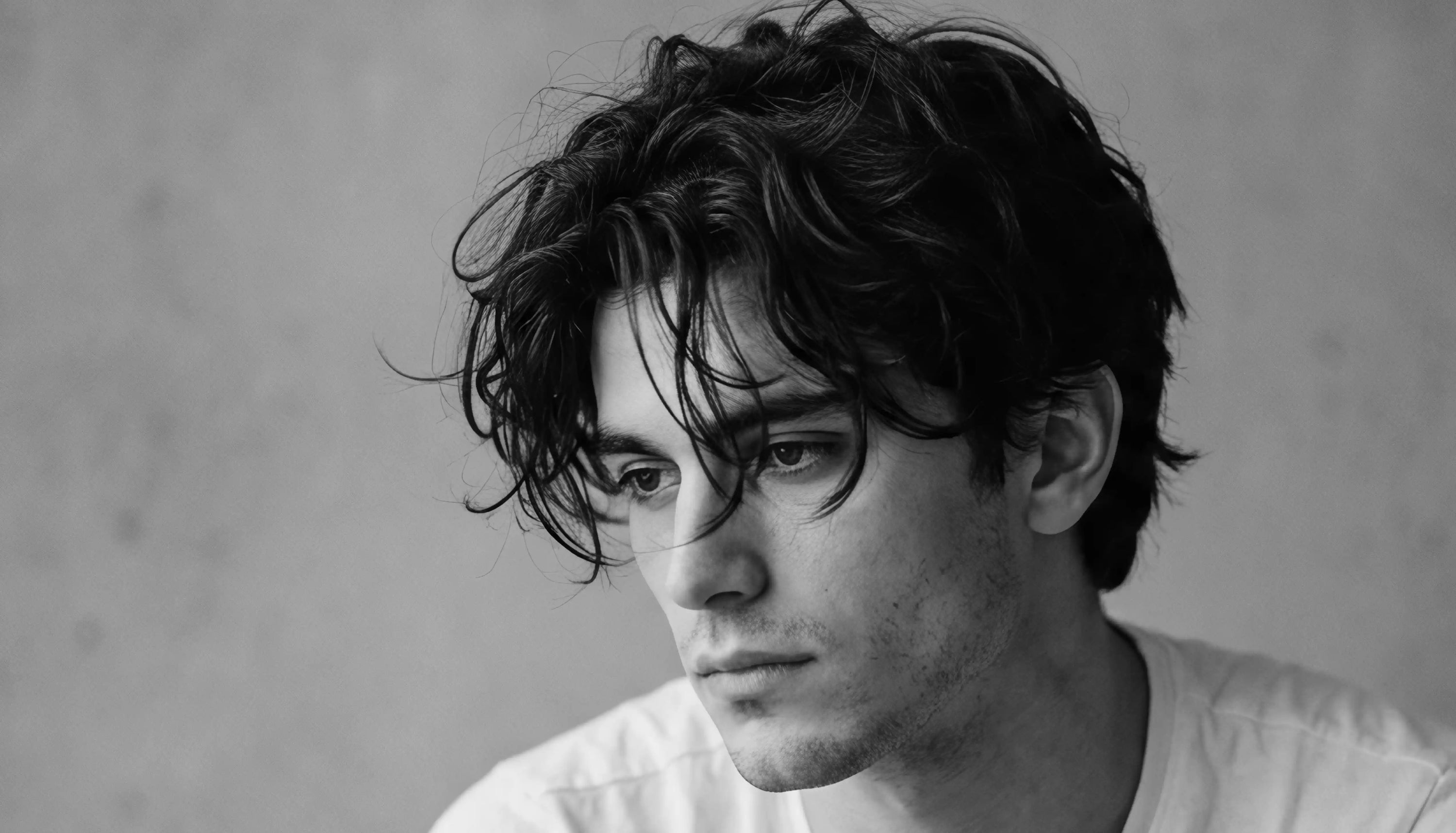 Shot of male model with medium length hair style with fringe in black and white