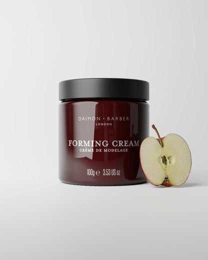 Jar of 100g Forming Cream with apple on grey background.