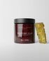 Jar of Daimon Barber Texture Clay 100g with a honeycomb on a light gray background