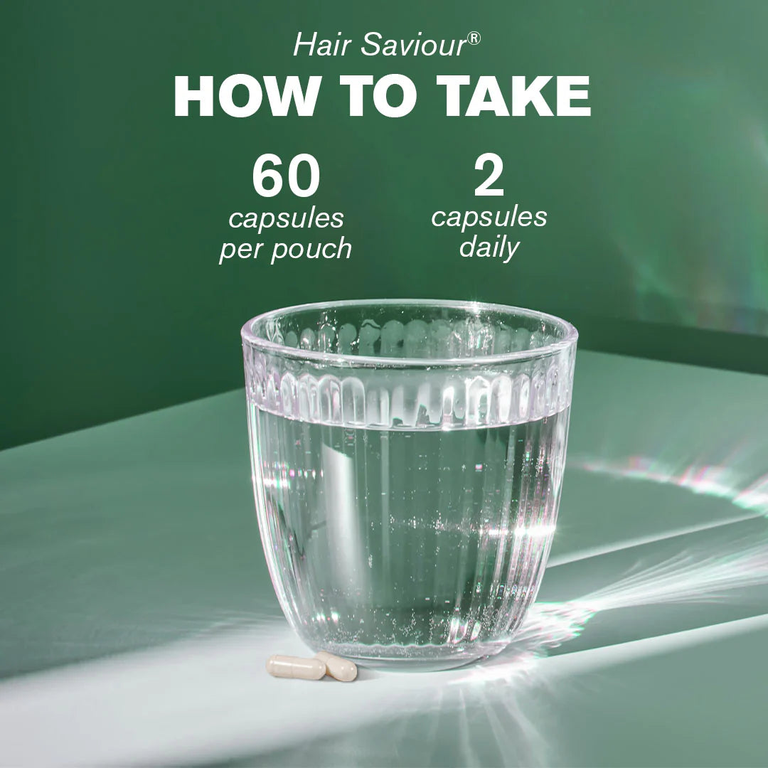 Glass of water with two capsules on a green background, promoting Hair Saviour supplement usage.