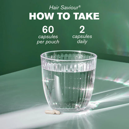 Glass of water with two capsules on a green background, promoting Hair Saviour supplement usage.